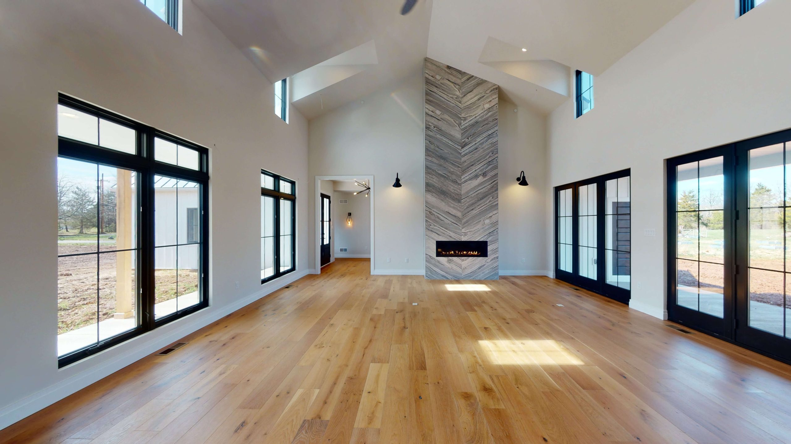 large living area with big windows along each wall